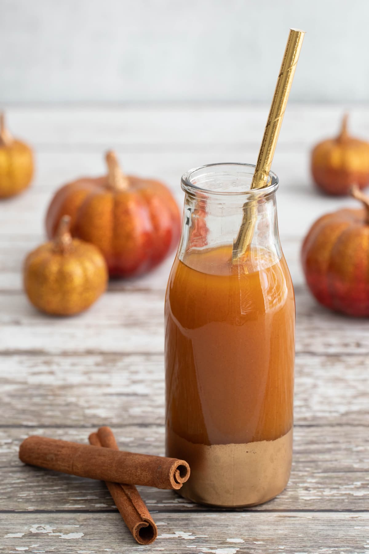Pumpkin juice with gold straw