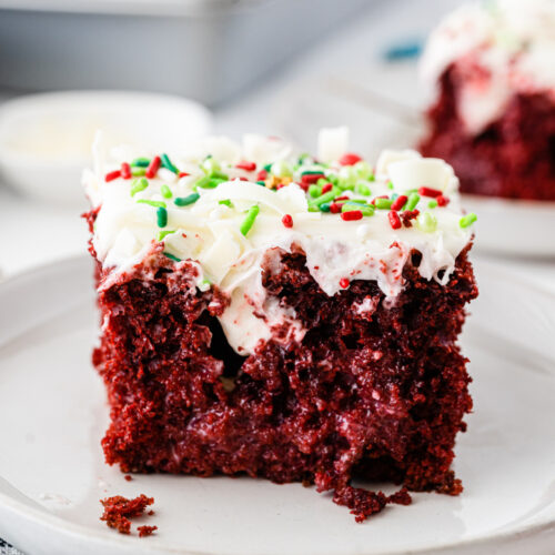 A slice of red velvet cake on a plate, perfect for Christmas celebrations.