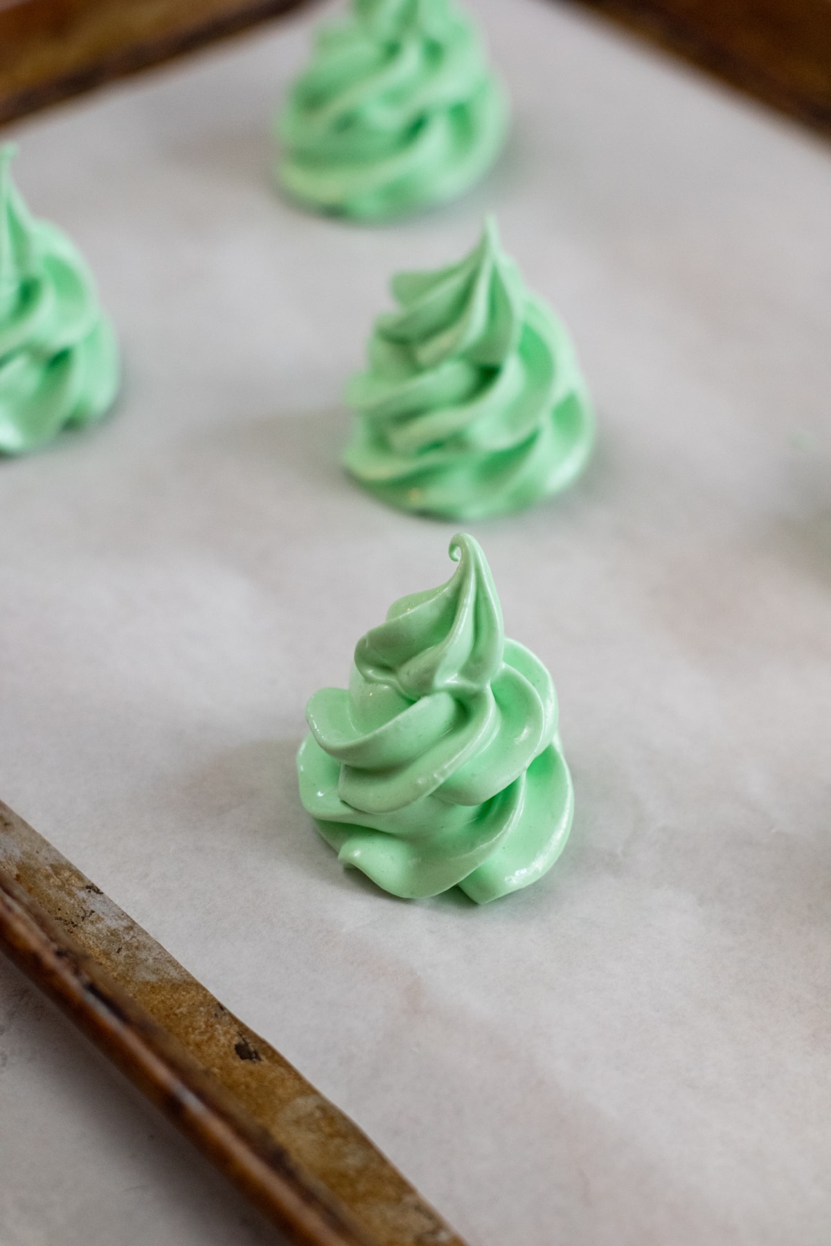Meringue Christmas tree on cookie sheet lined with parchment paper