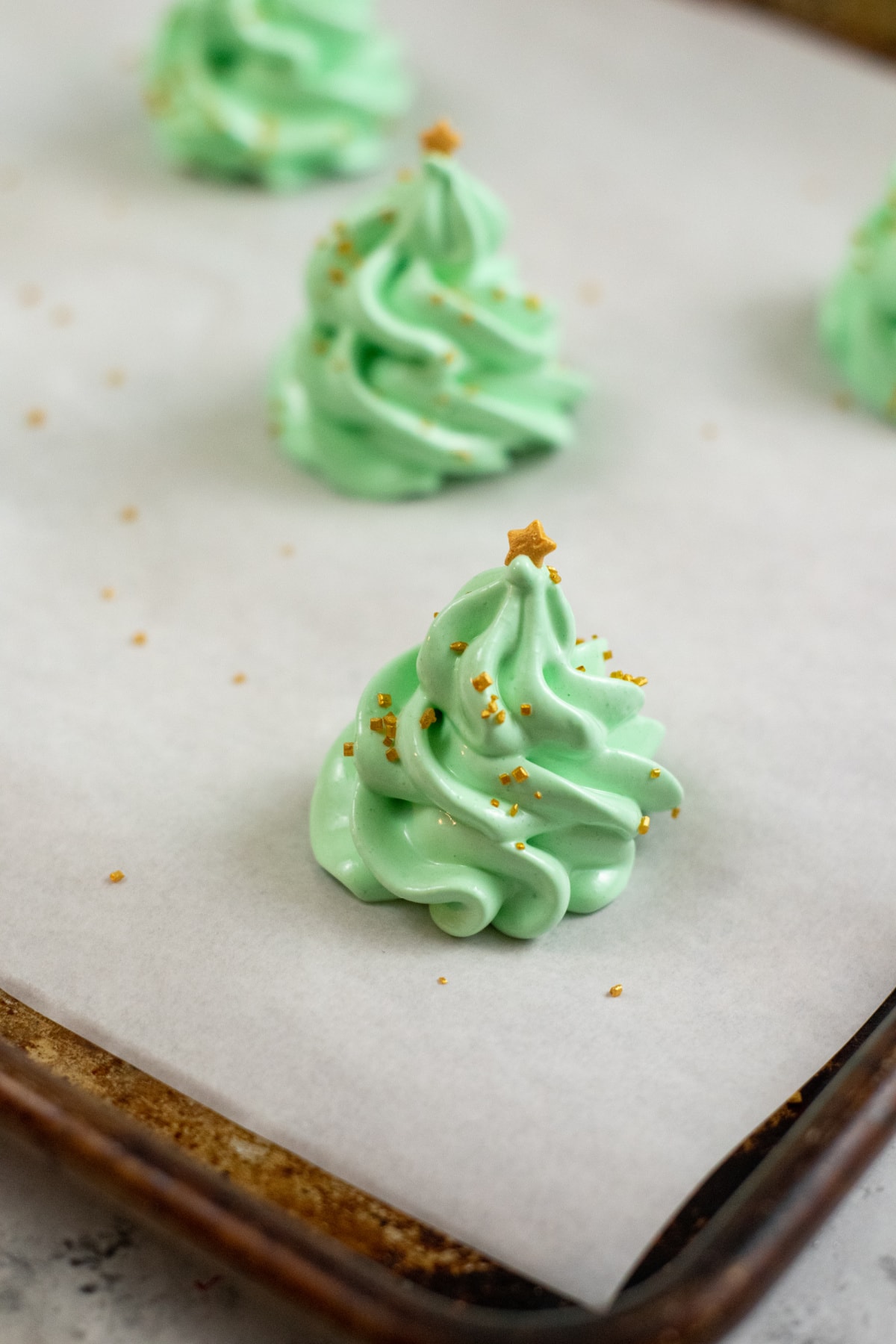 Christmas tree meringue with gold star and sprinkles