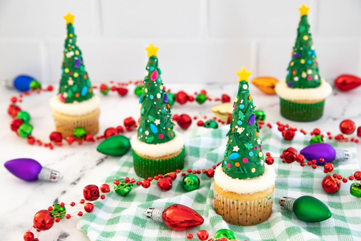 Christmas tree cupcakes on green checkered napkin