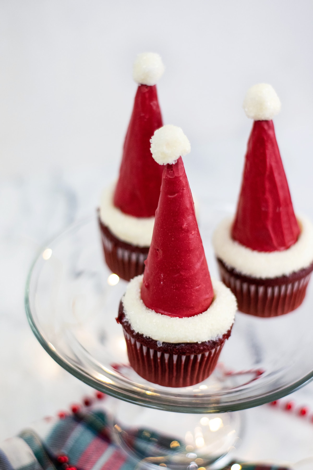 Santa hat cupcakes on glass plate
