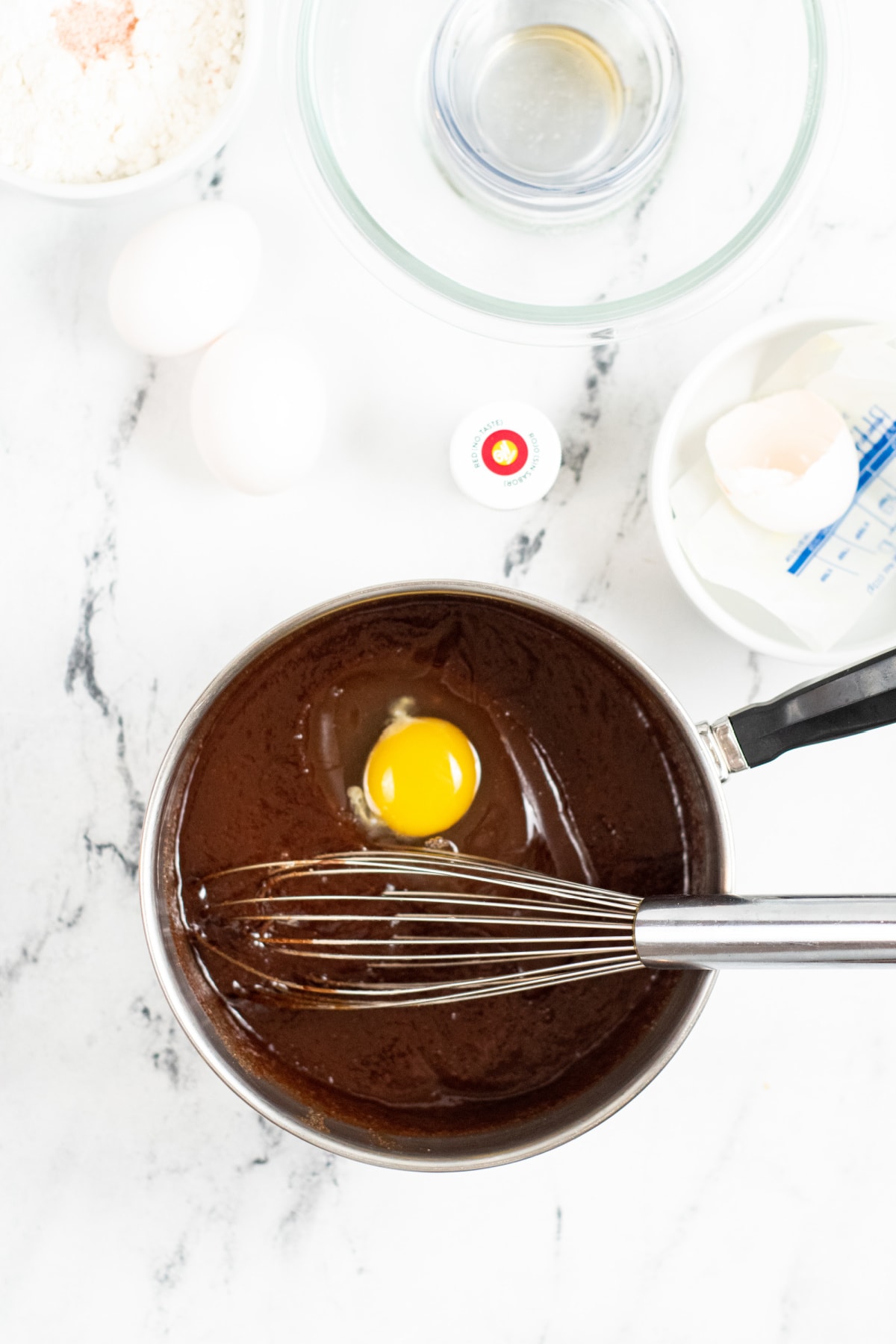 Egg added to saucepan with melted chocolate