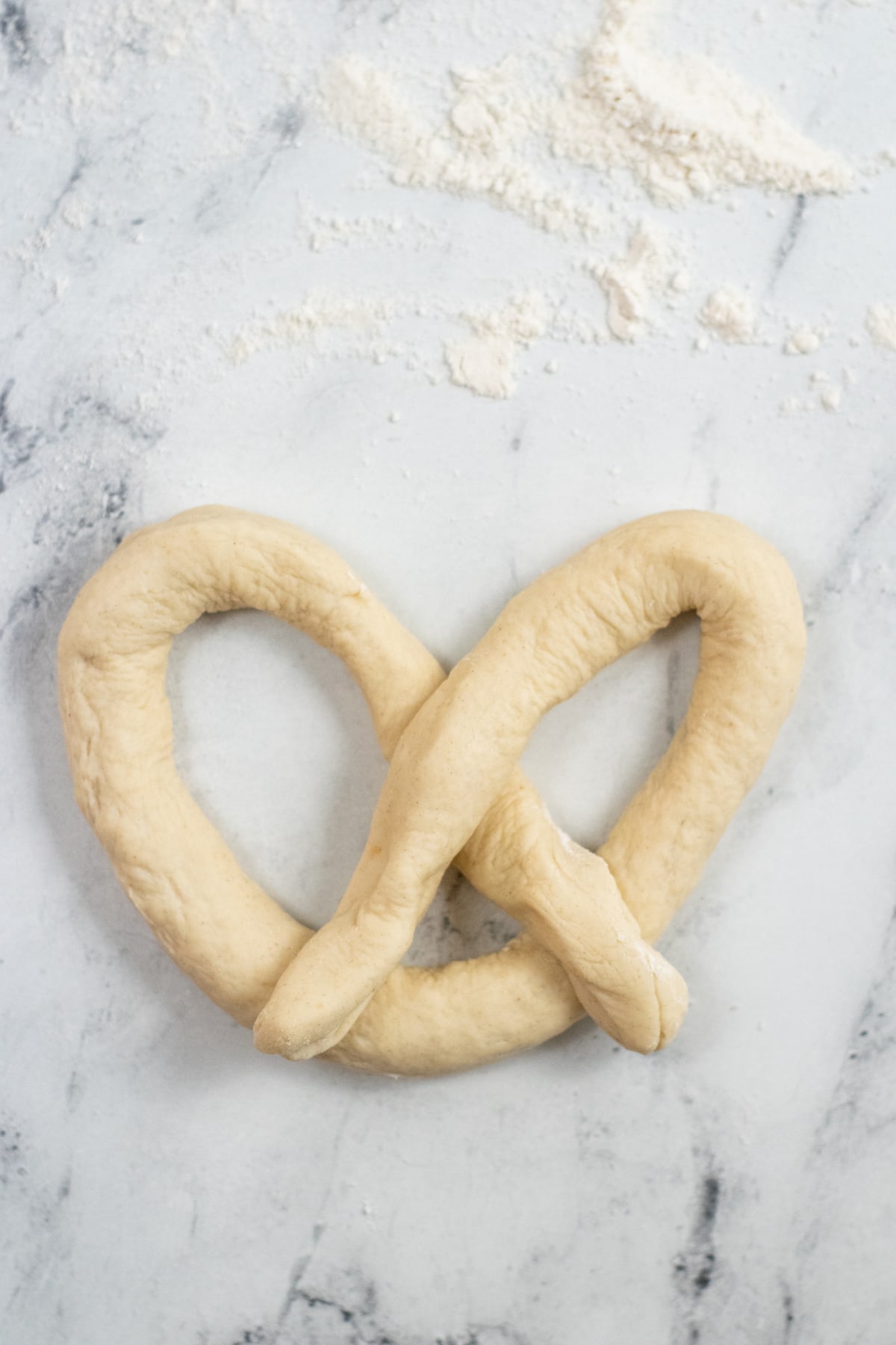 Forming a pretzel shape with dough