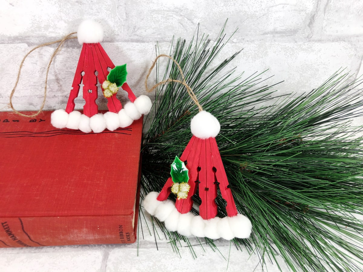 Clothespin Santa hats on book and pine branch