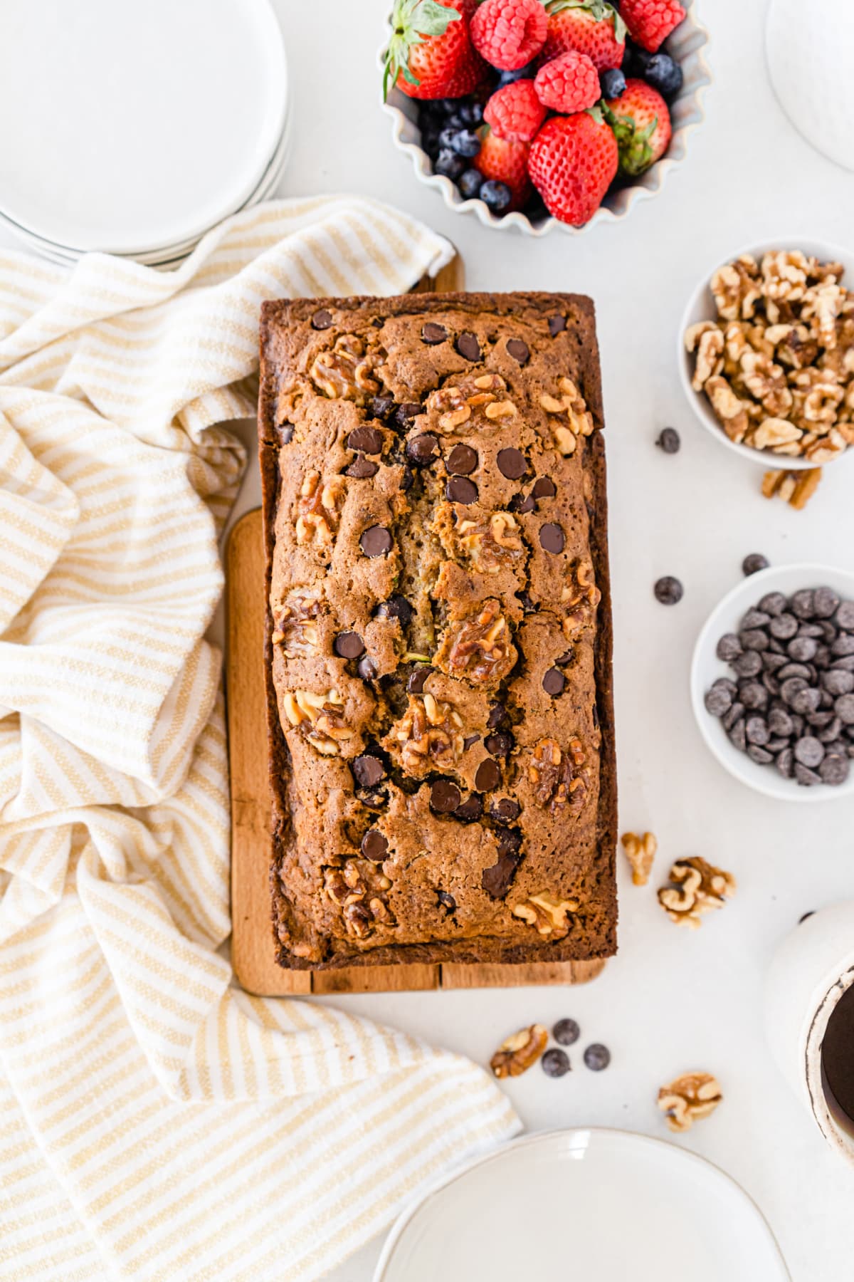 Chocolate chip zucchini bread surrounded by berries, nuts and chips
