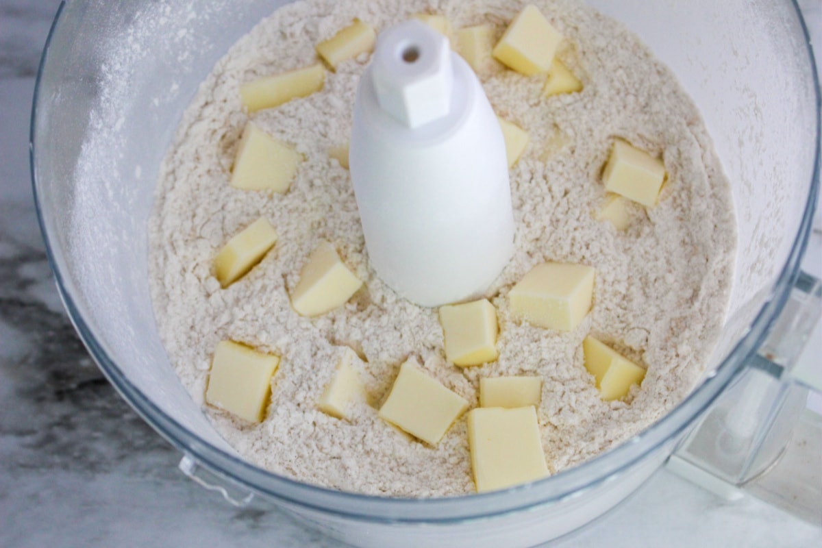 Adding cubes of butter to dry ingredients