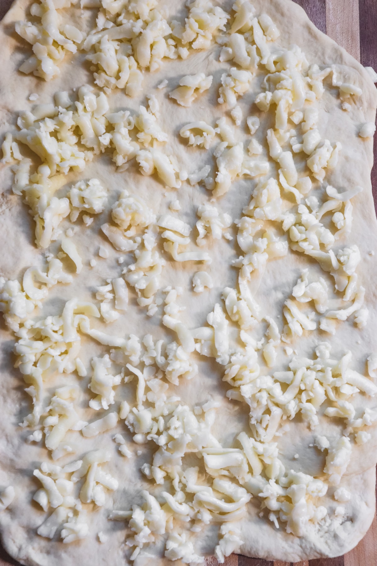 Dough topped with mozzarella cheese