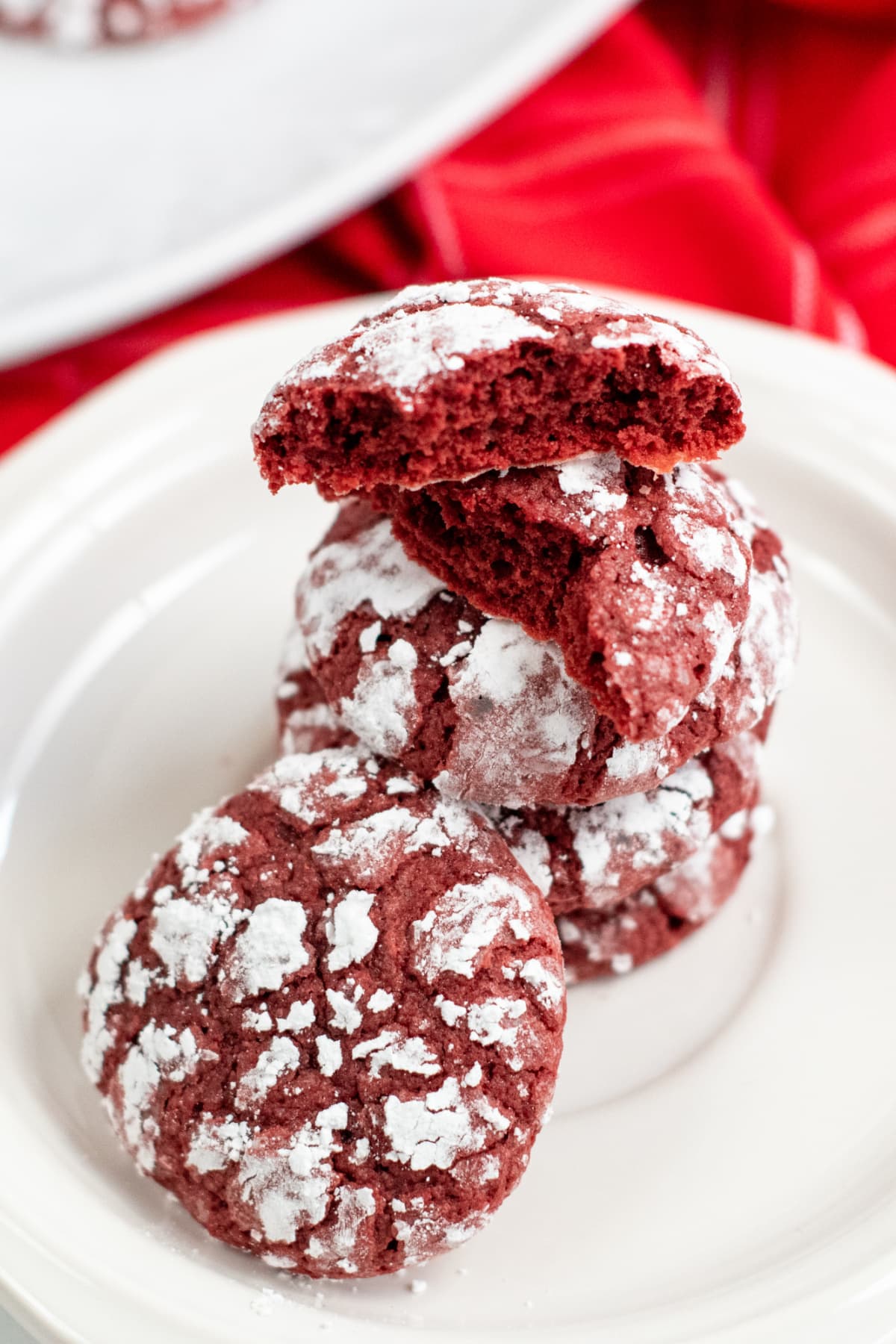 Red Velvet Crinkle Cookies stacked on plate