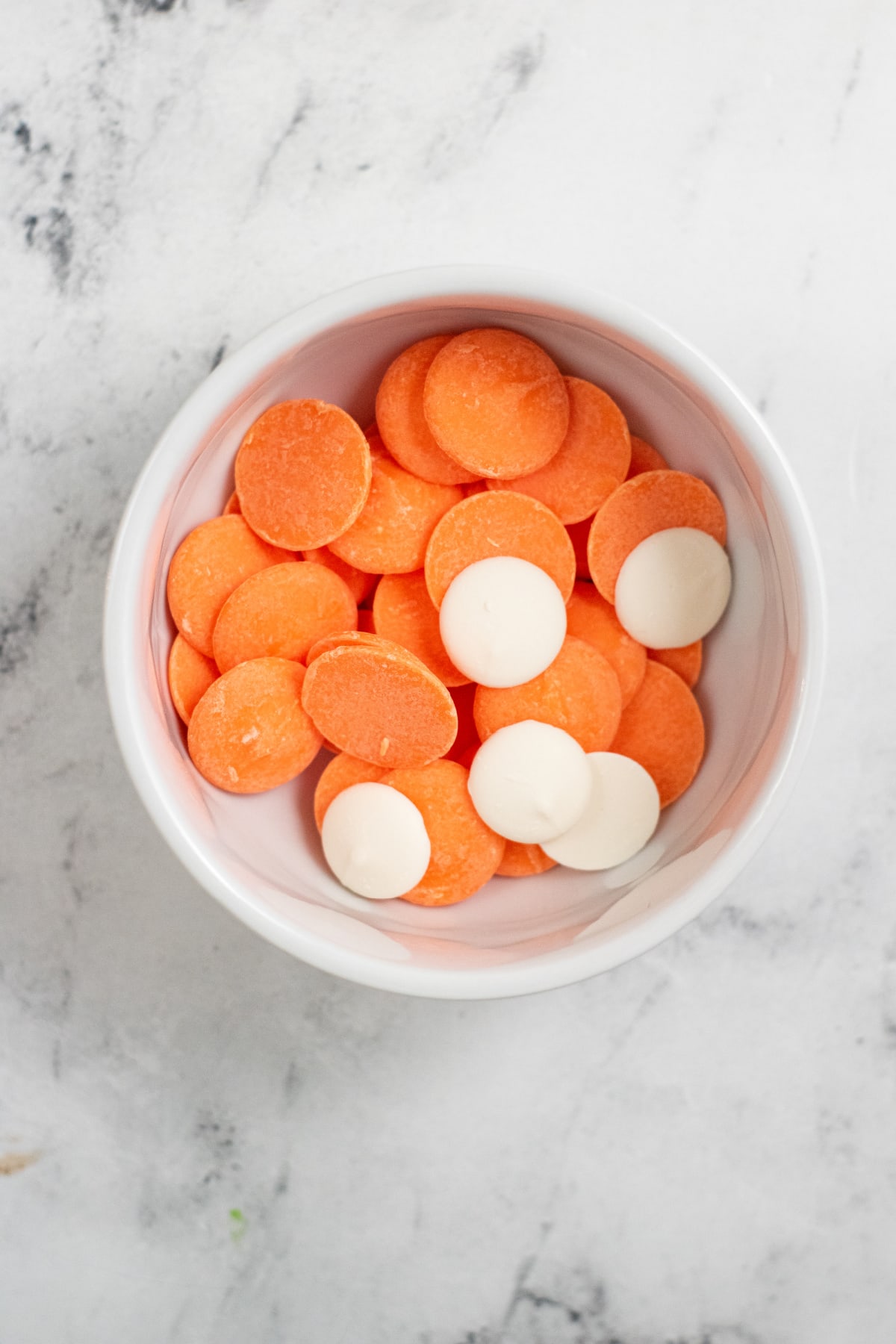 Orange and white candy melts in bowl