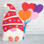 Gnome Valentine holding balloons