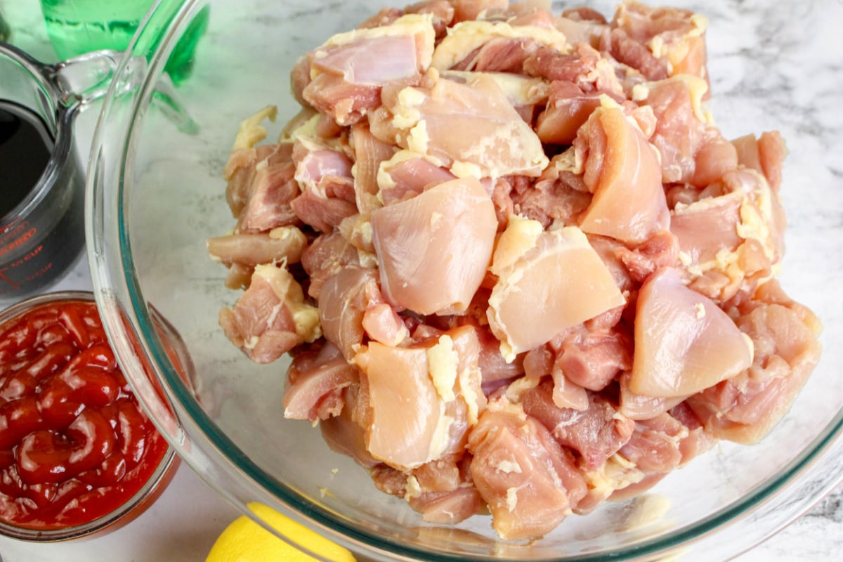 Cut chicken thighs in a bowl