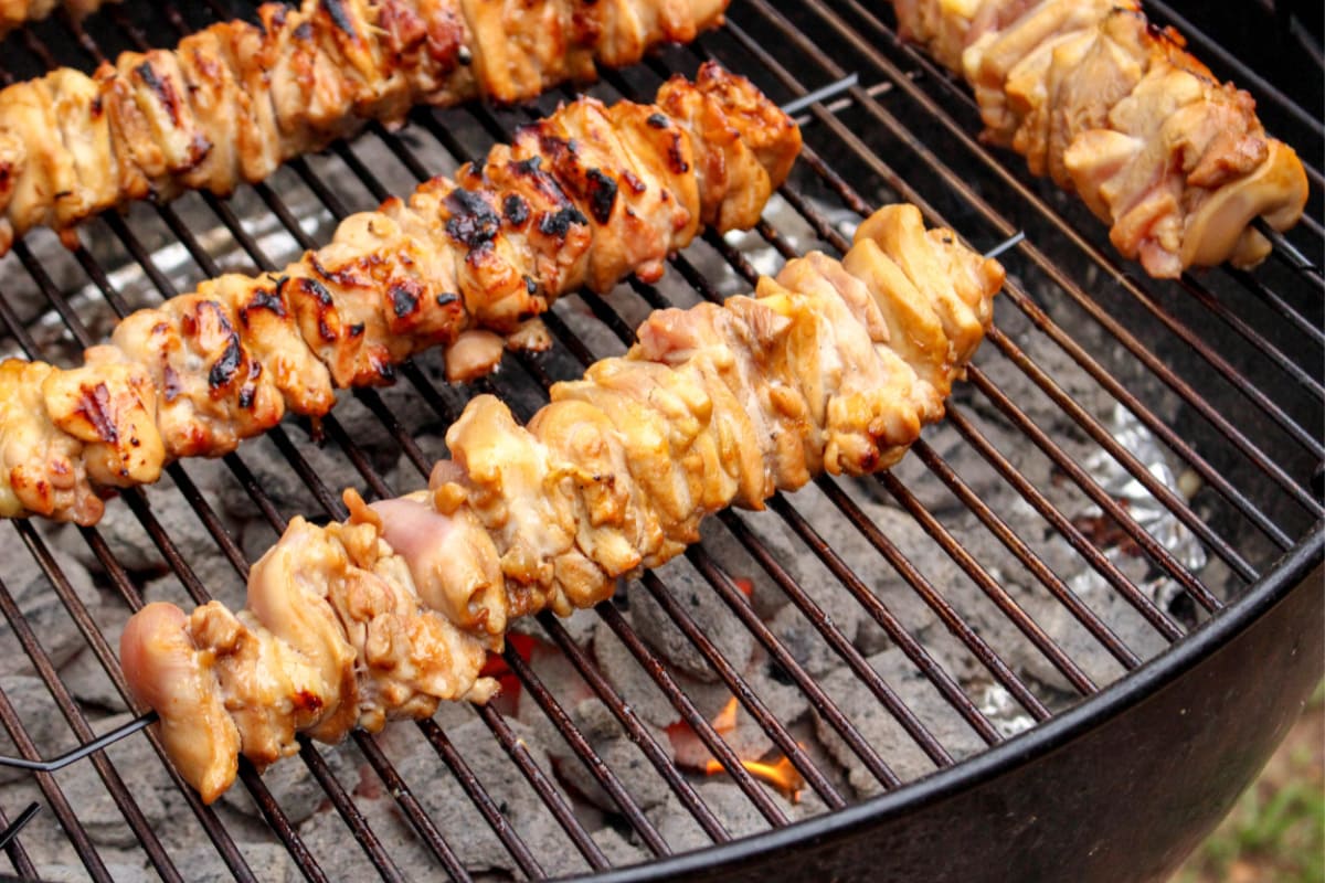 Chicken kabobs cooking on grill