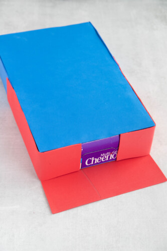 Cereal box covered in red and blue craft foam