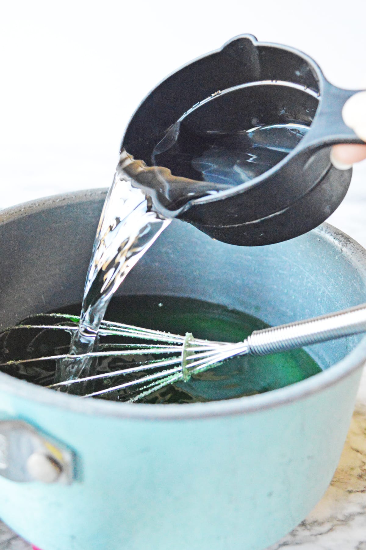 Adding cold water to St. Patrick's jello mixture