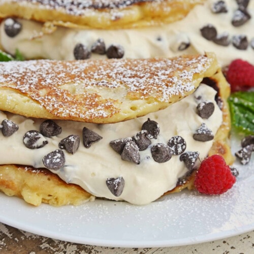 Cannoli Pancakes with berries on white plate