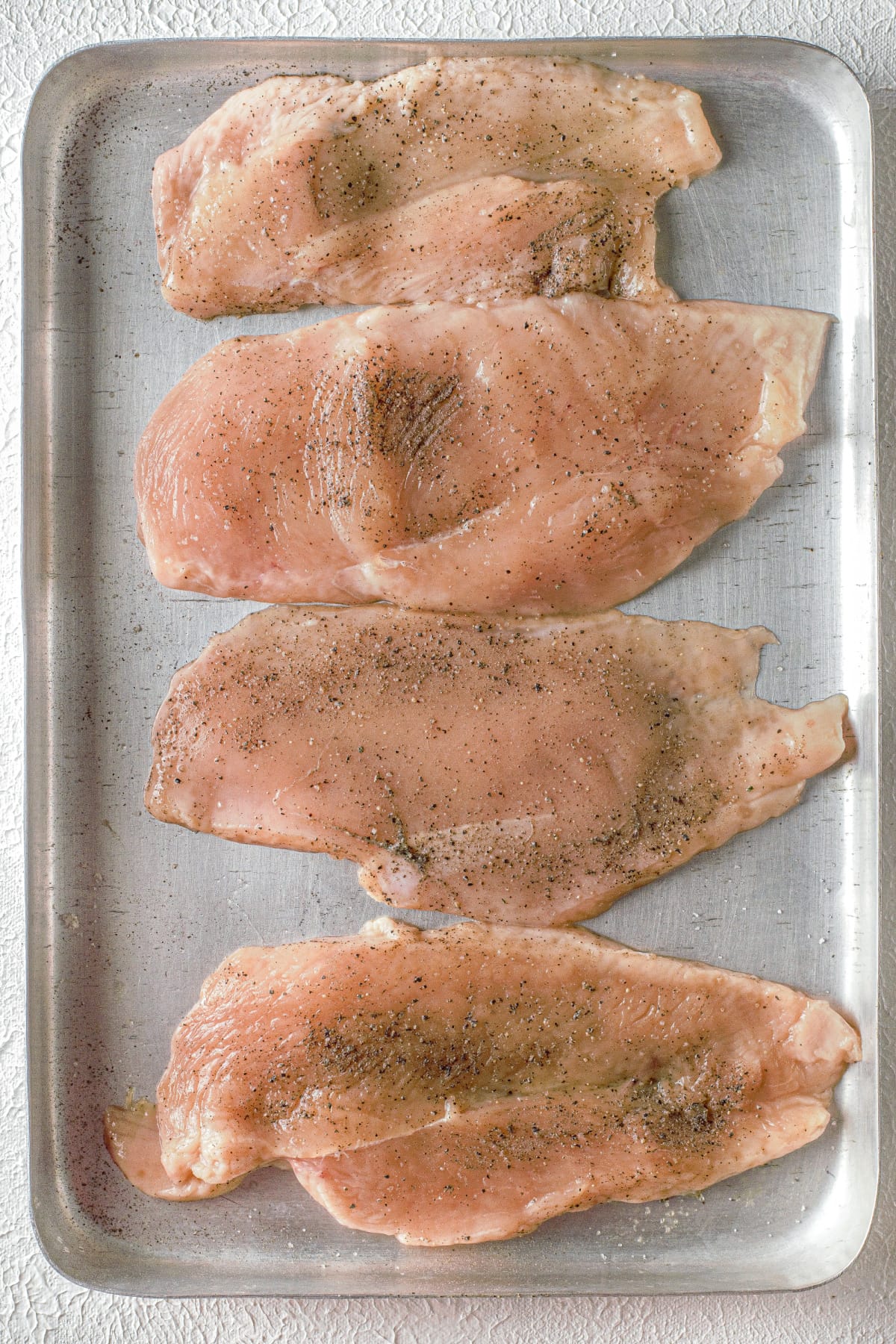 Chicken breasts on a baking pan