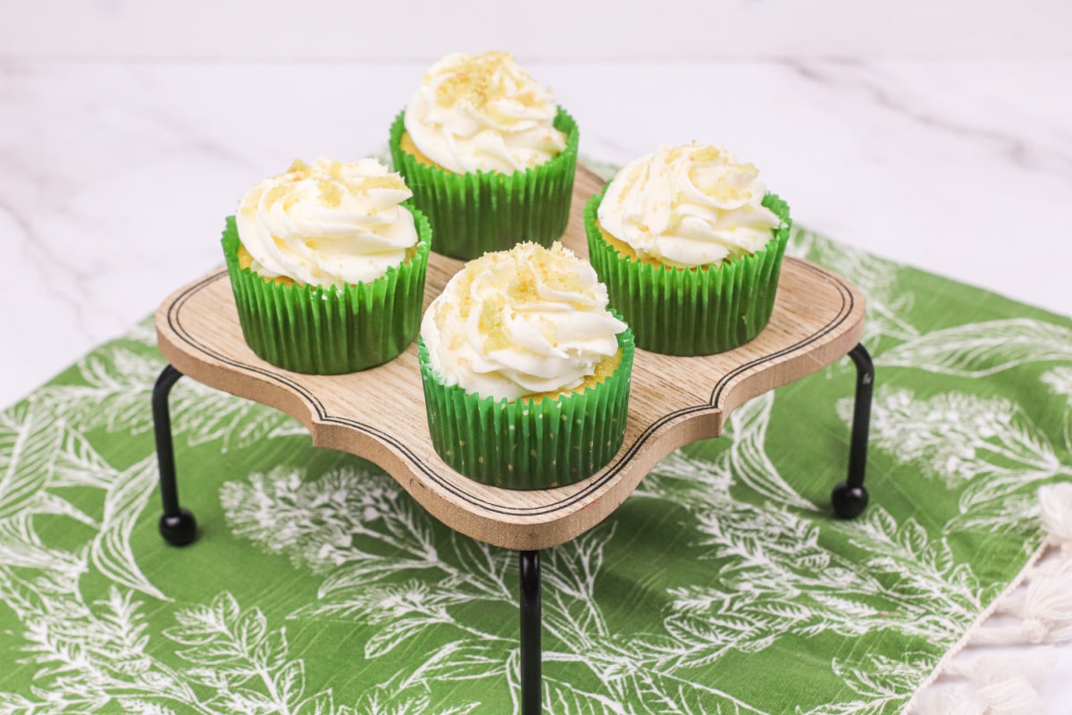 Coconut lime cupcakes on wooden board