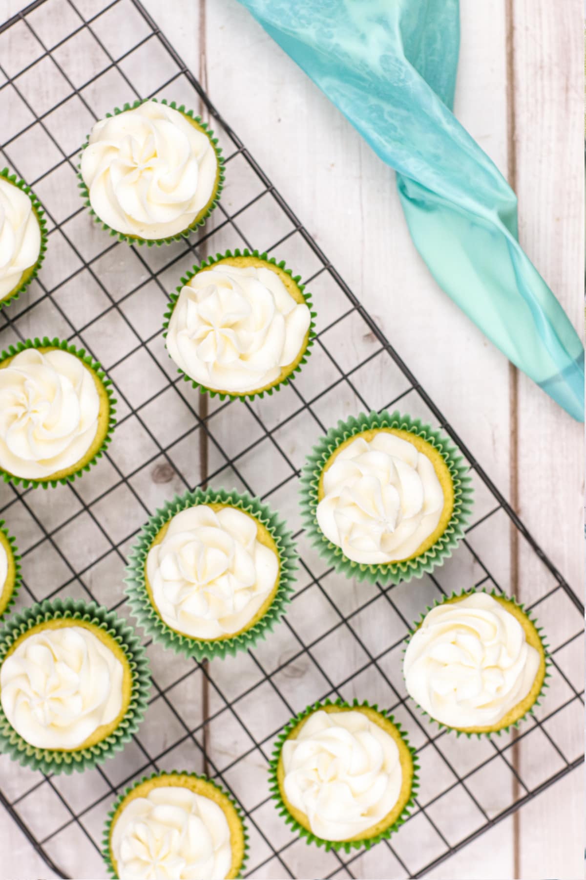 Piping bag and frosted cupcakes
