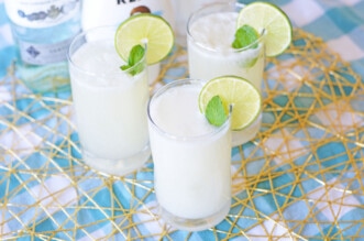 Three coconut mojitos with slices of lime