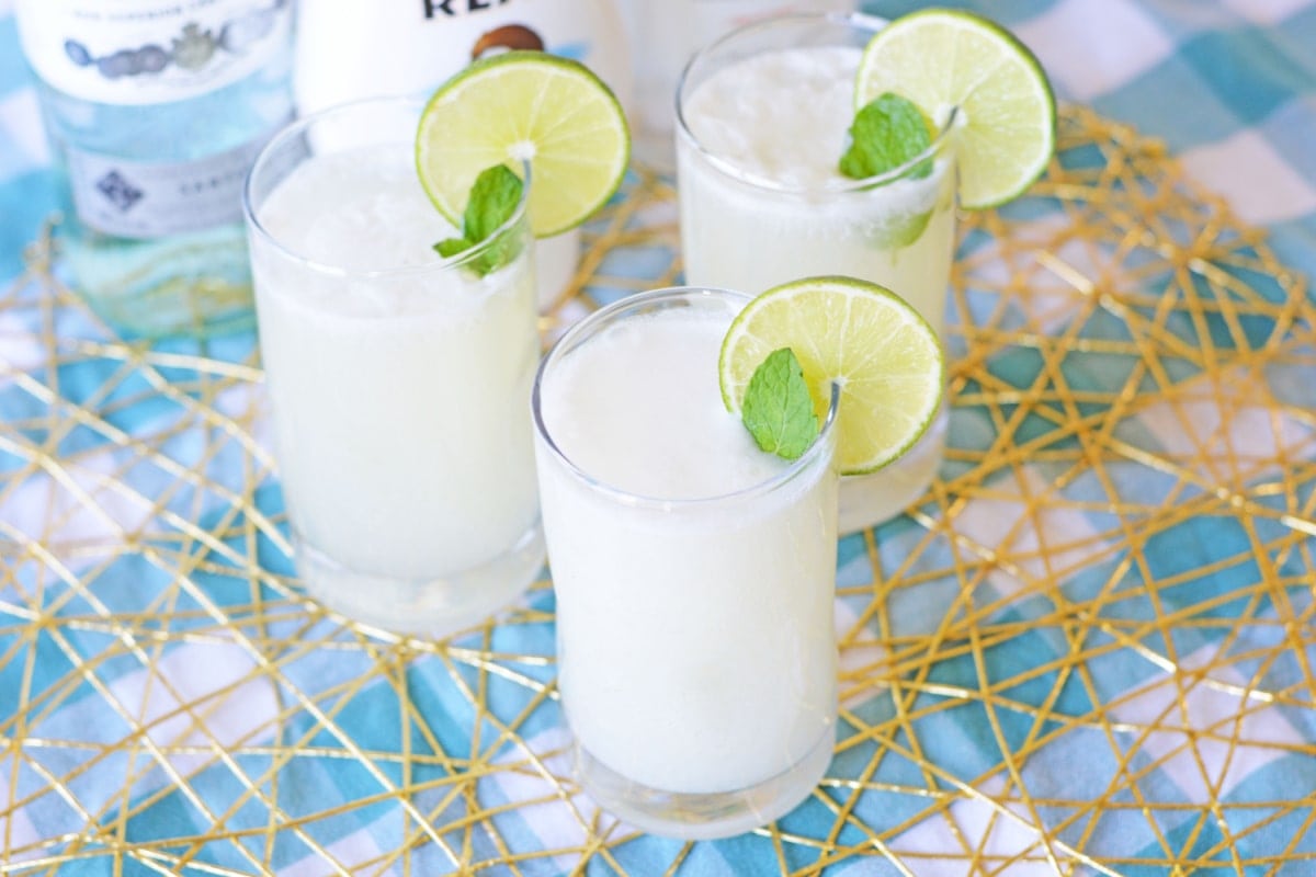 Three coconut mojitos with slices of lime