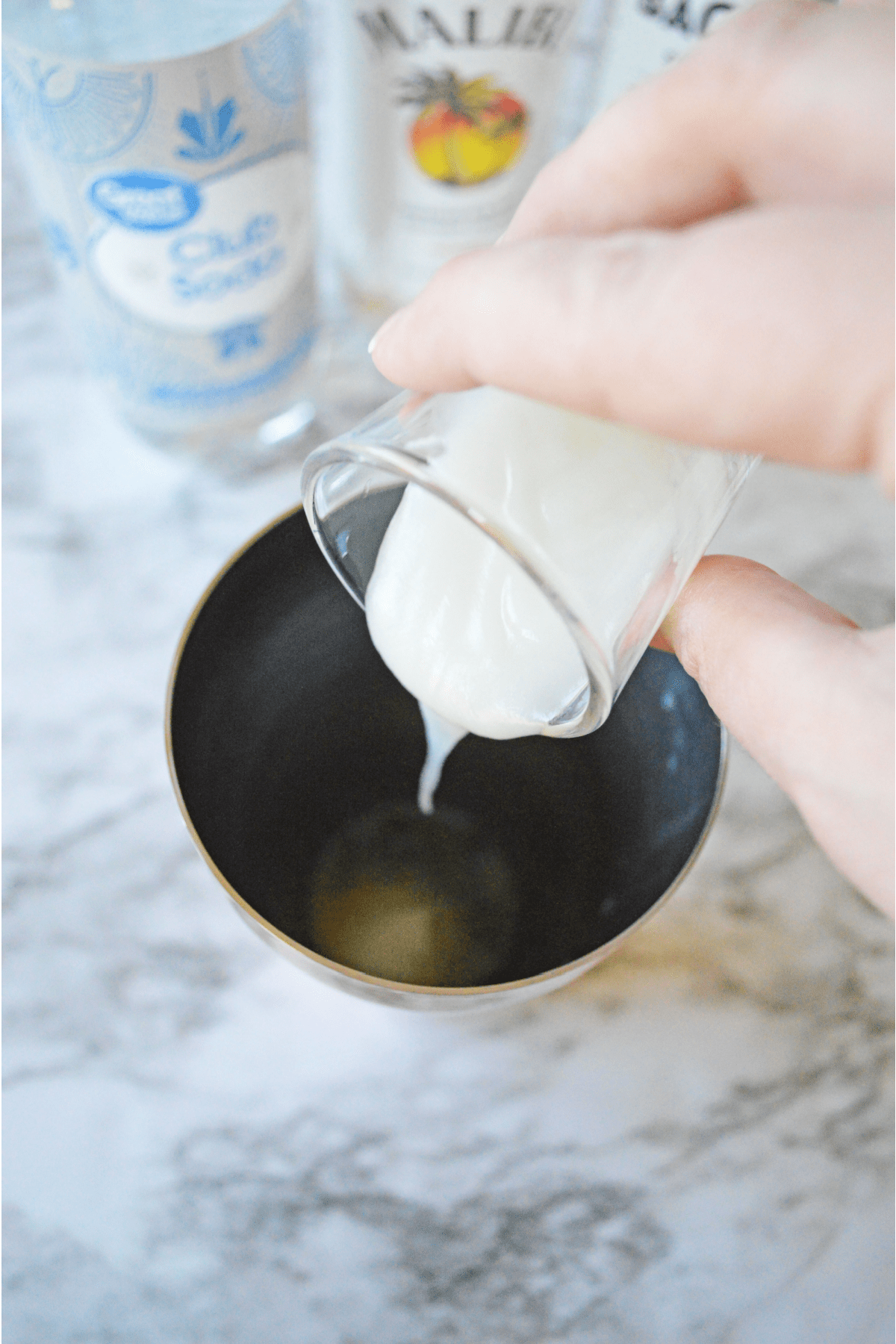 Pouring cream of coconut into the mint mixture