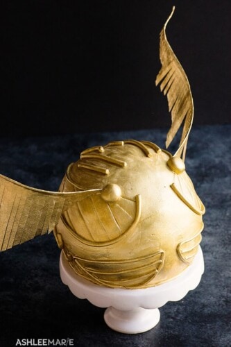 Golden snitch cake with black background
