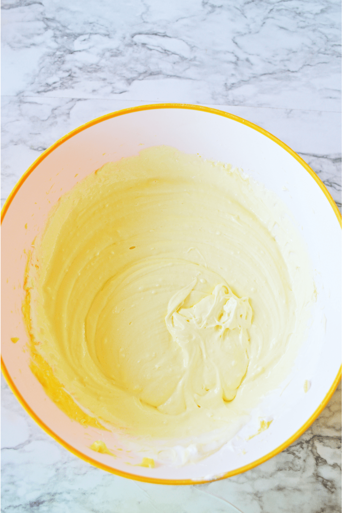 Lemon pudding and cream cheese combined in mixing bowl