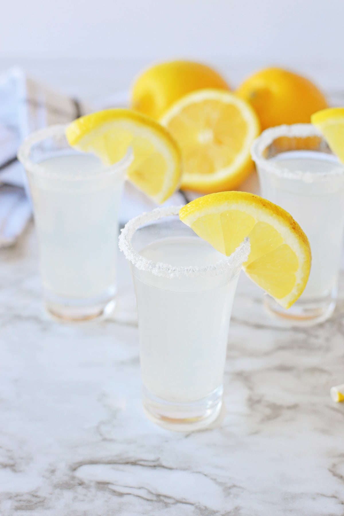Lemon drop shots with lemon wedges