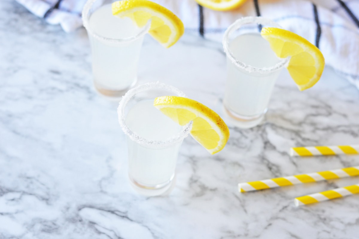 Lemon Drop Shots with sugar rims and lemon wedges