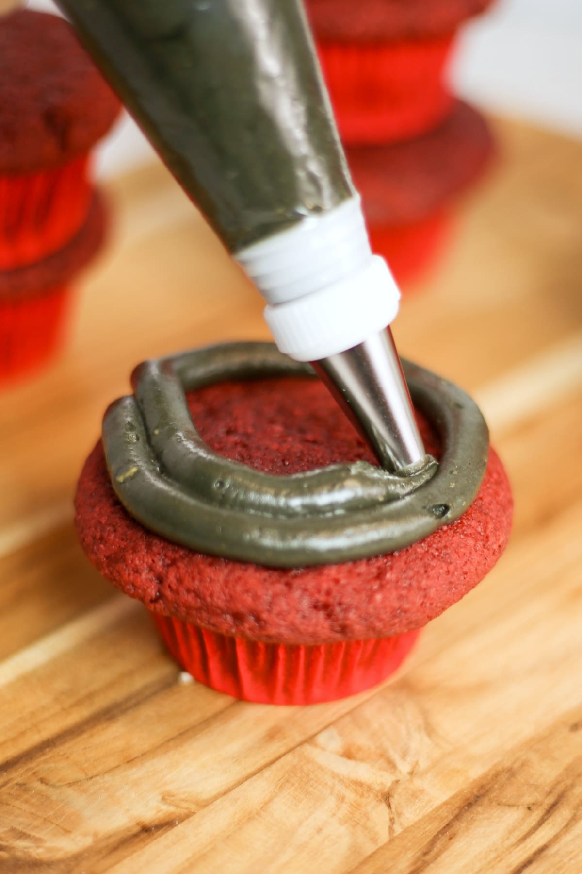 Black frosting on red velvet cupcake