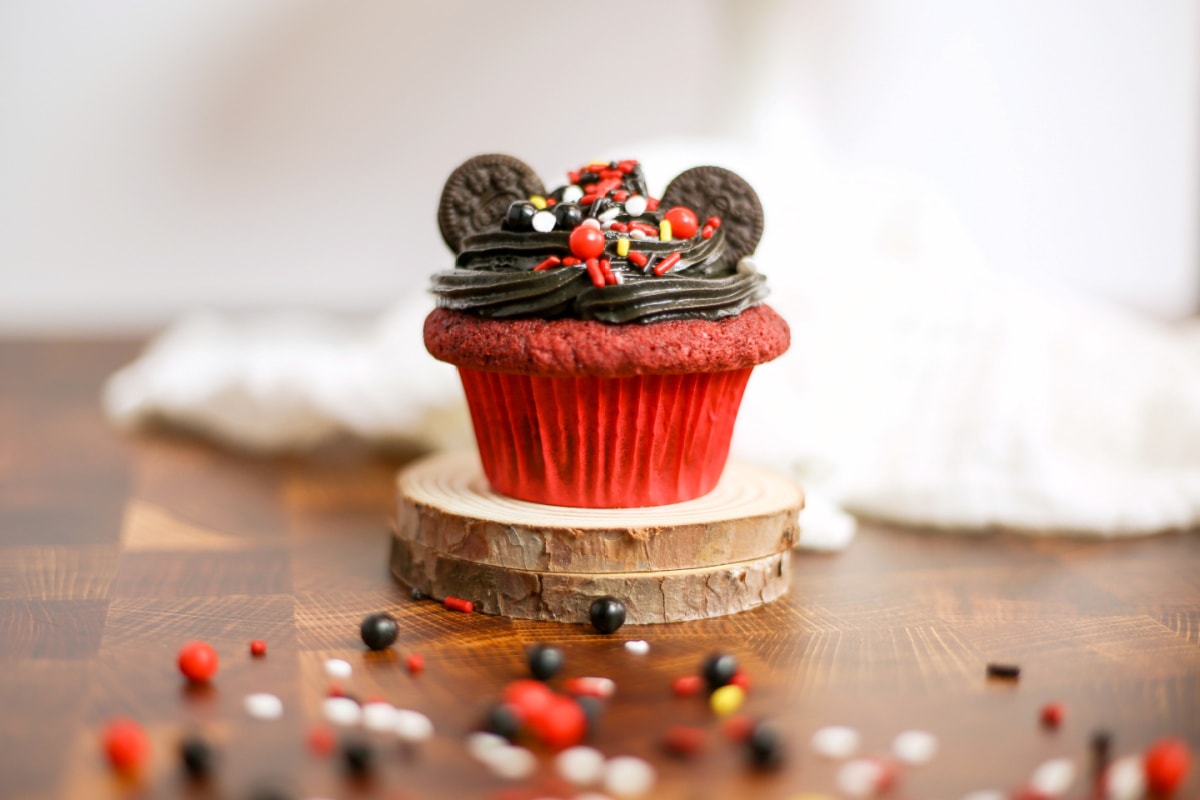Red velvet Mickey Mouse cupcake on wood circles
