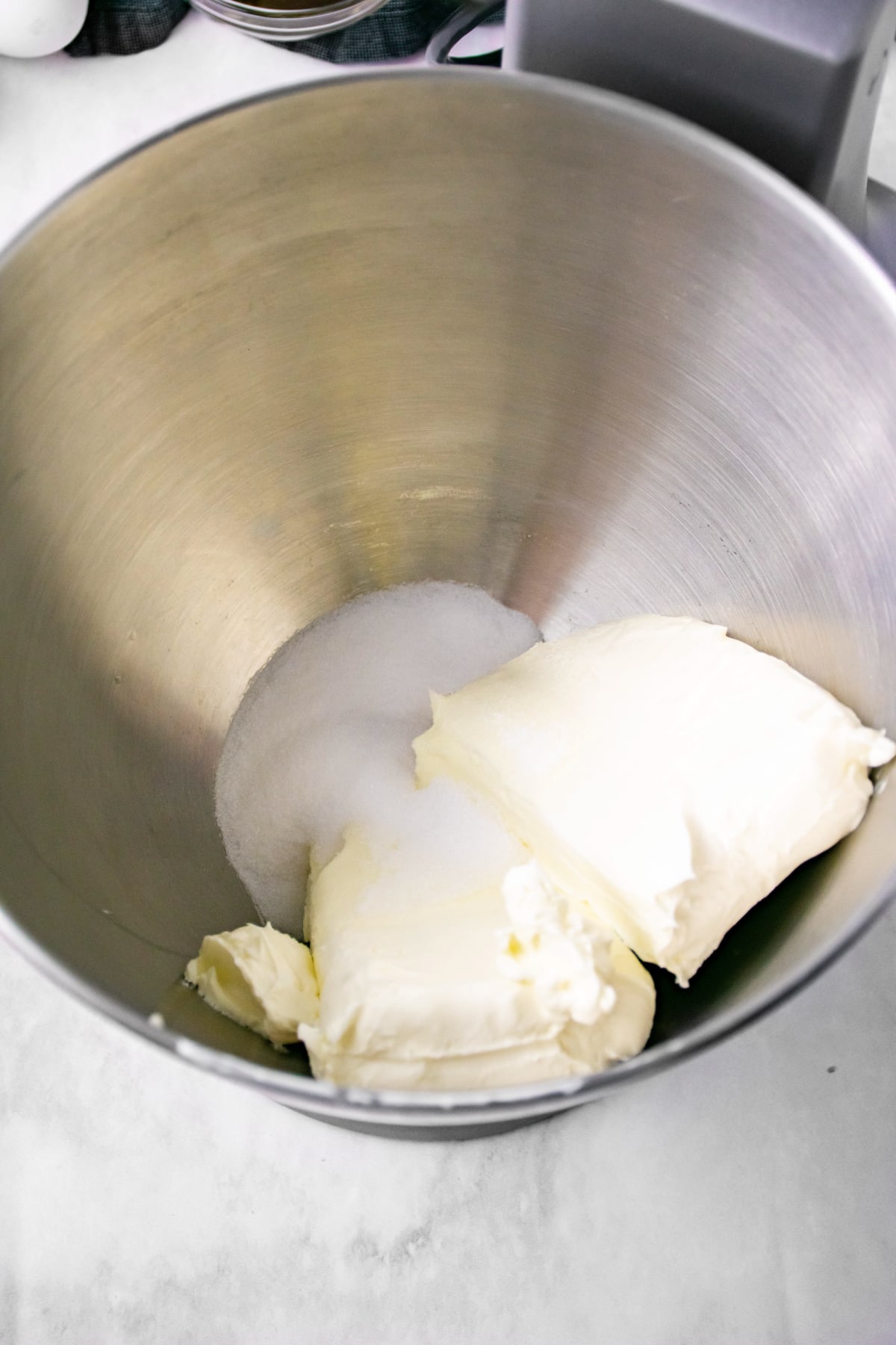 Cream cheese and sugar in bowl
