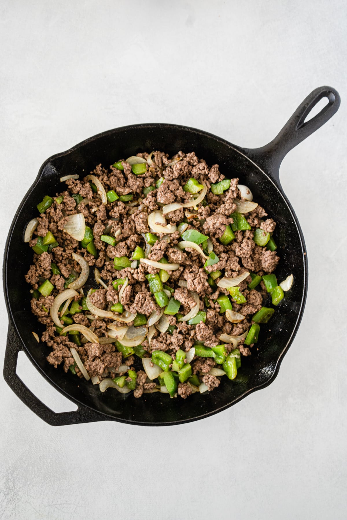 Pepper, onion and ground beef in skillet