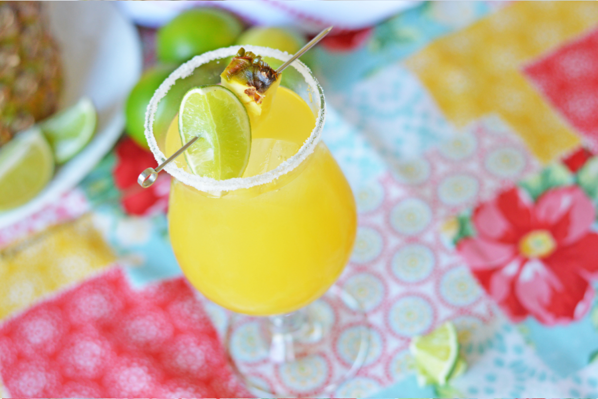 Pineapple margarita in margarita glass with colorful background