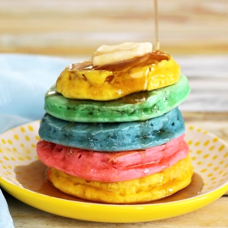 Rainbow pancakes with syrup
