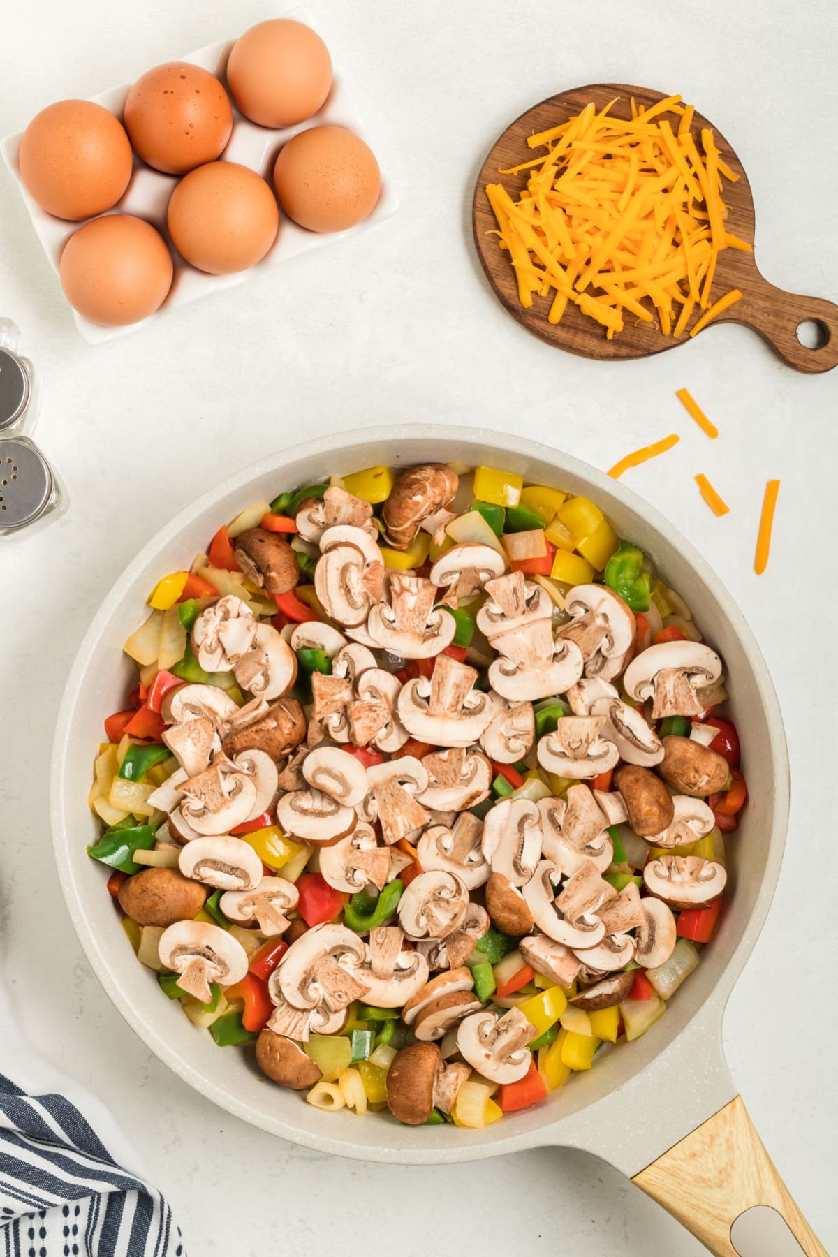 Sliced mushrooms on top of diced peppers