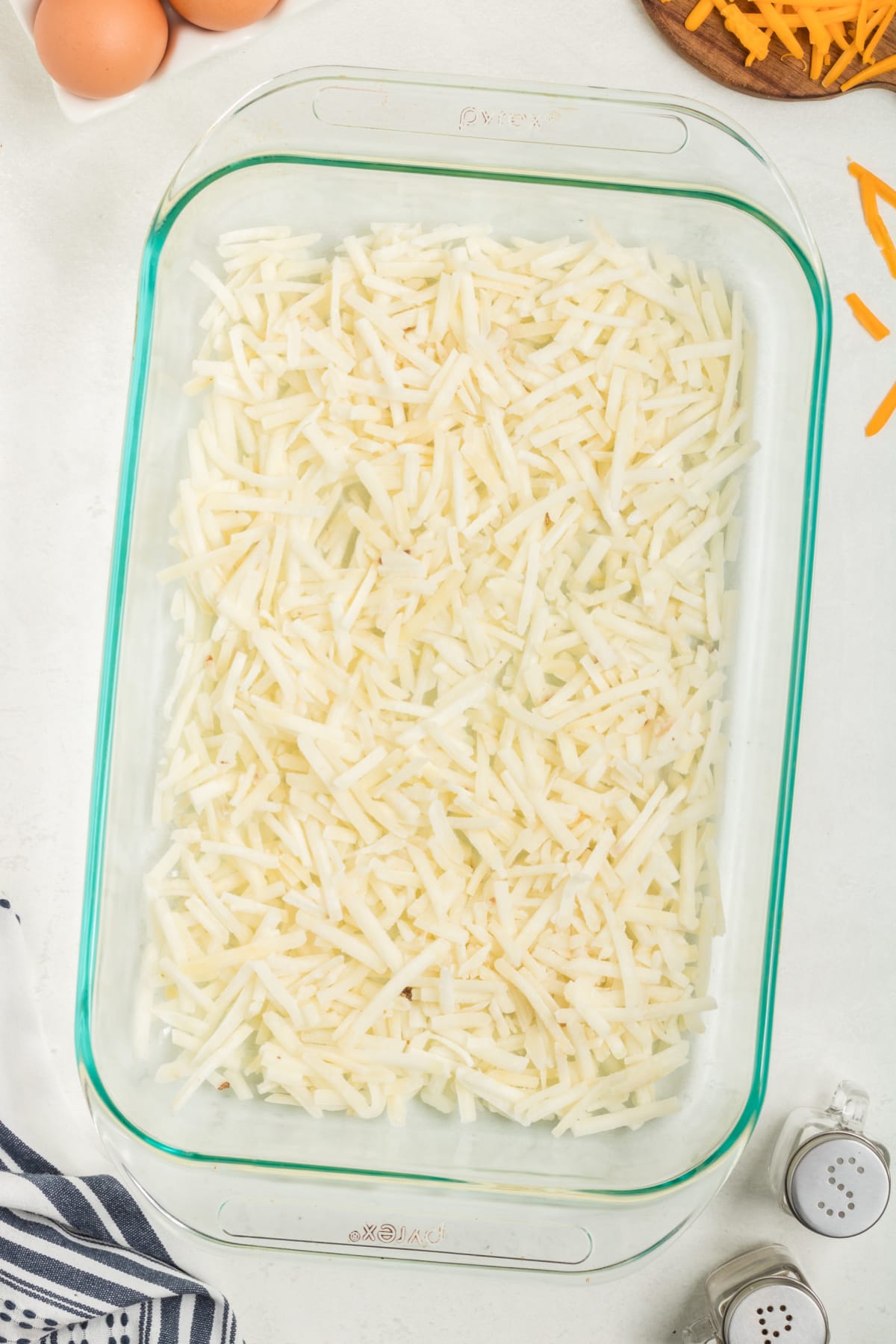 Frozen hash browns in glass baking dish