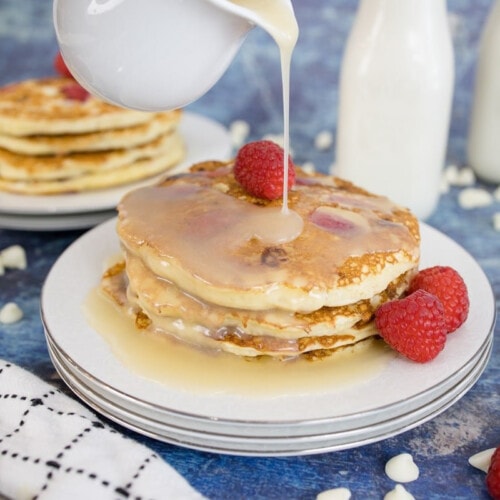 Syrup poured over White Chocolate Raspberry Pancakes