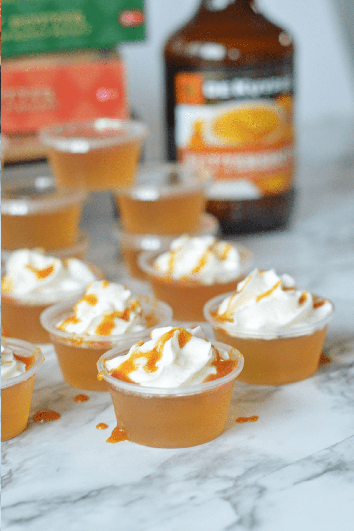 Butterbeer jello shots with schnapps in background