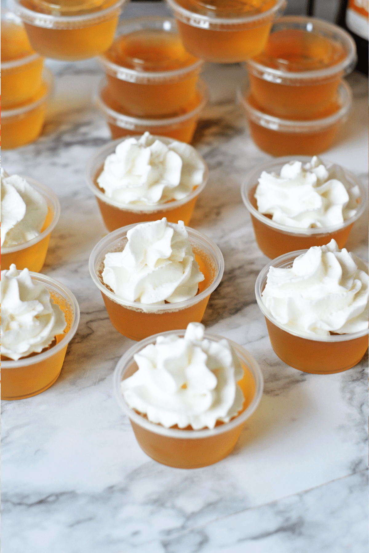 Butterbeer jello shots topped with whipped cream