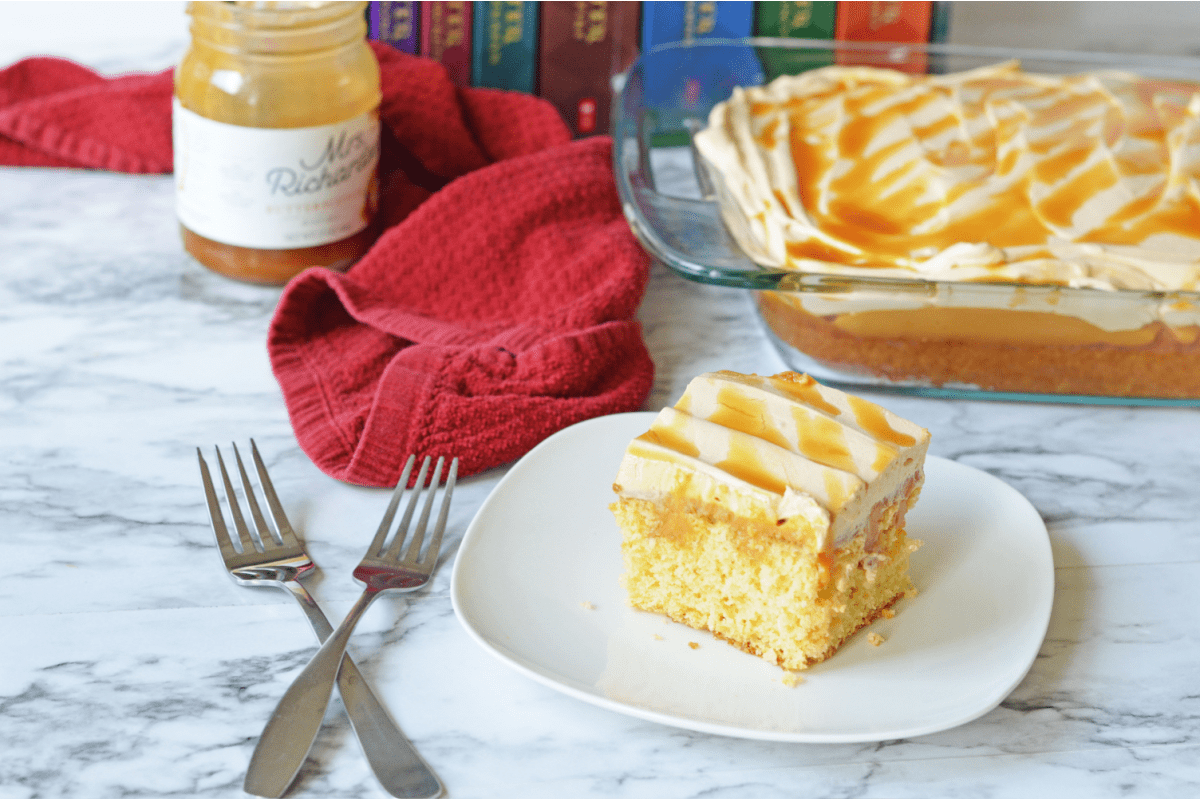 Butterbeer poke cake with forks criss crossed nearby