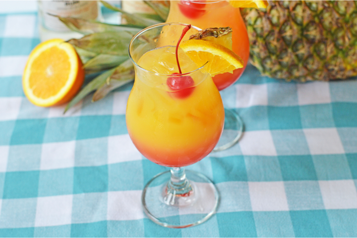 Caribbean Rum Punch with sliced orange and a pineapple
