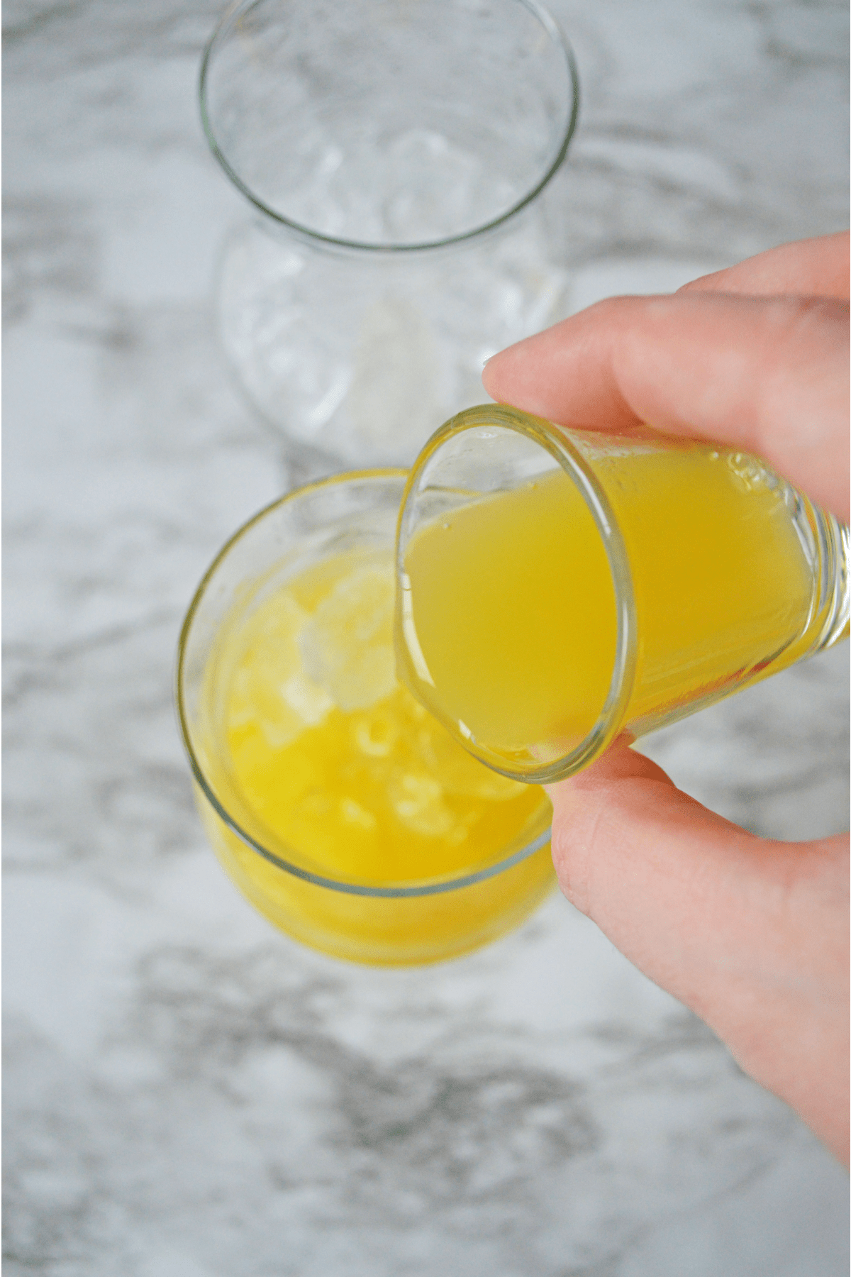 Orange juice being poured into glass