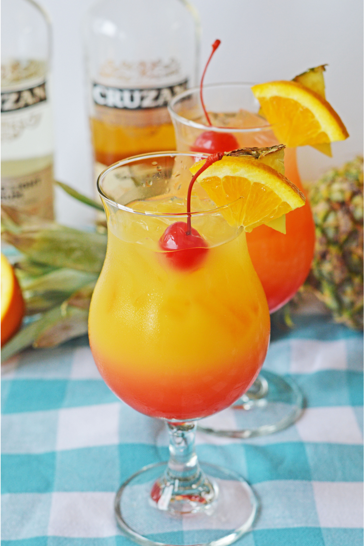 Caribbean rum punch with rum bottles in the background