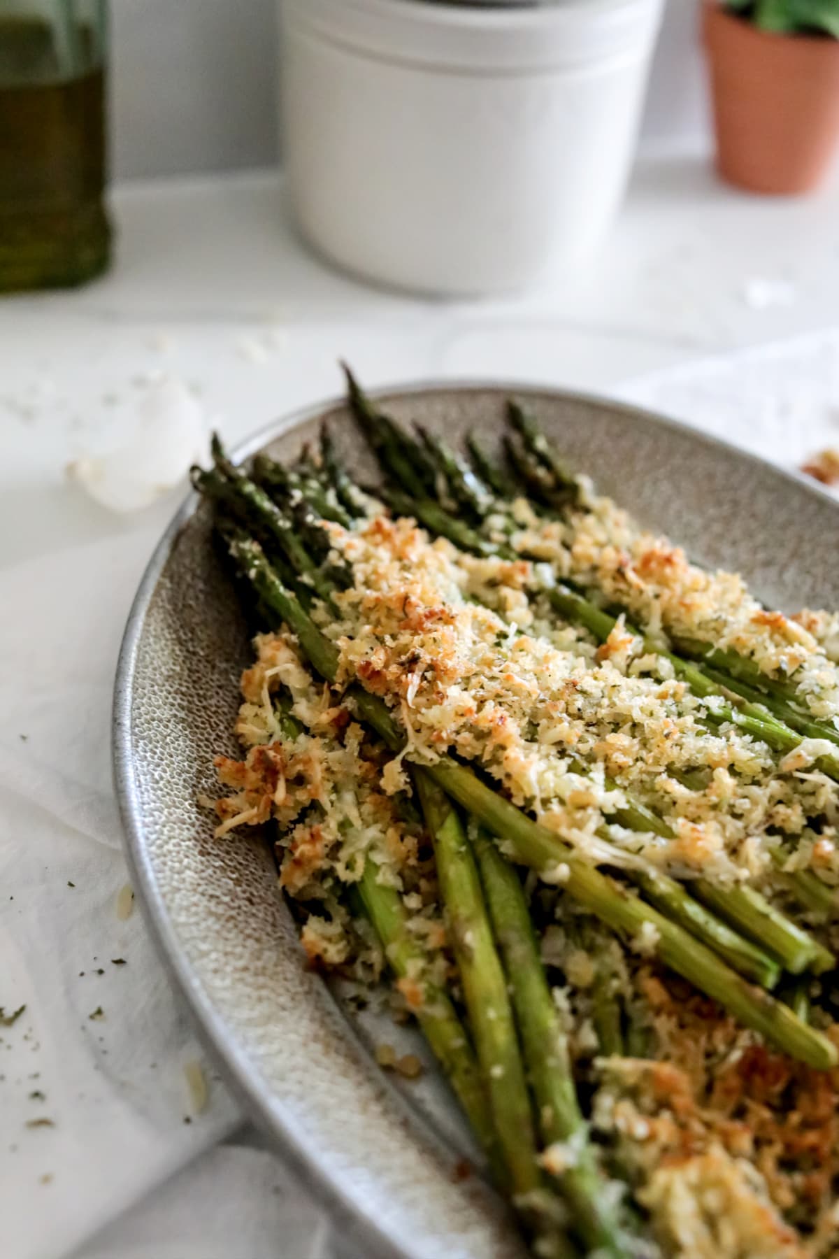 Garlic Parmesan Asparagus on silver plate with white tablecloth