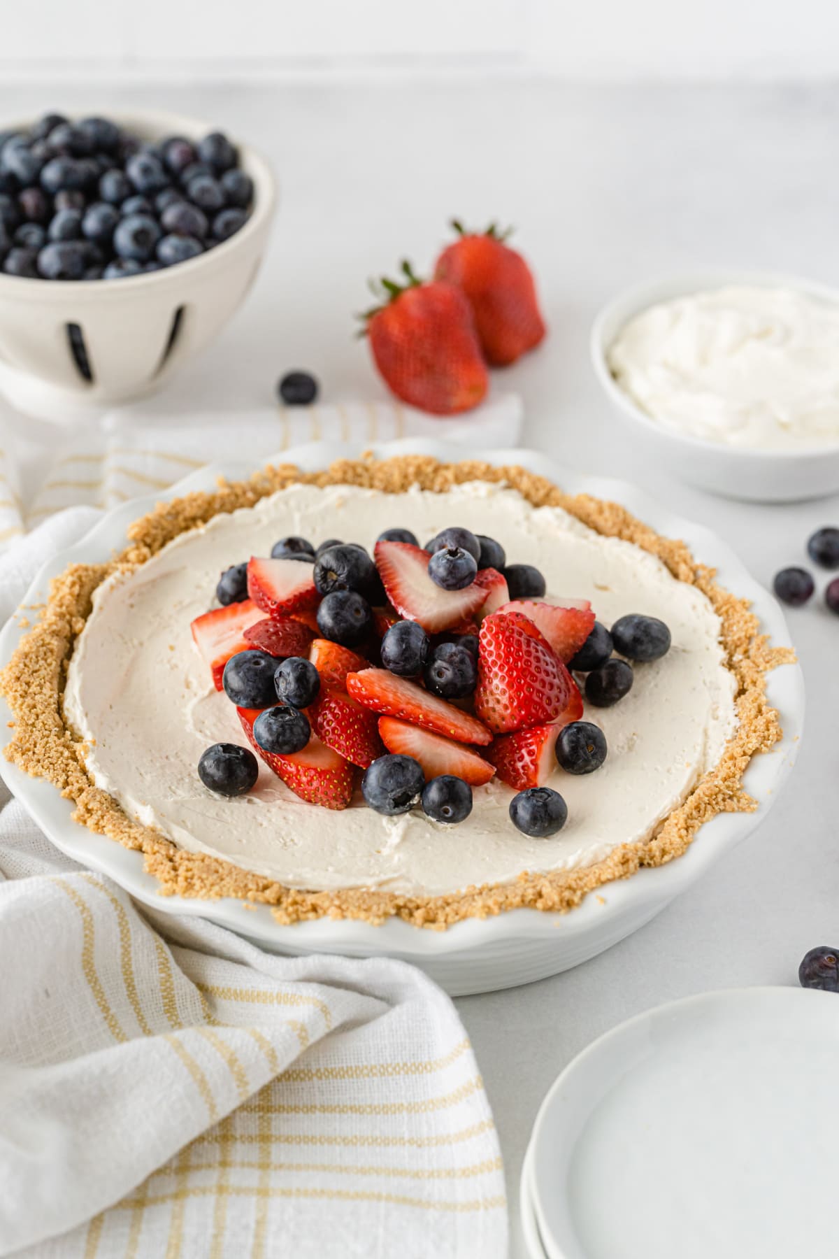 No bake cool whip cheesecake with berries and striped napkin