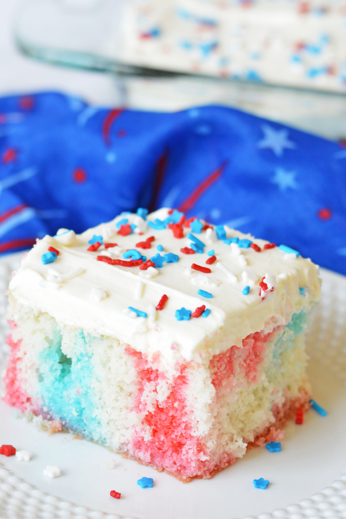 Slice of red white and blue poke cake