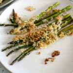 Roasted garlic parmesan asparagus on white plate