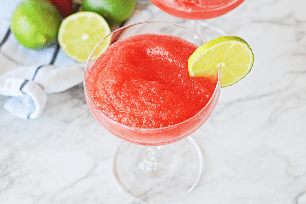 Frozen strawberry daiquiri with lime wedge